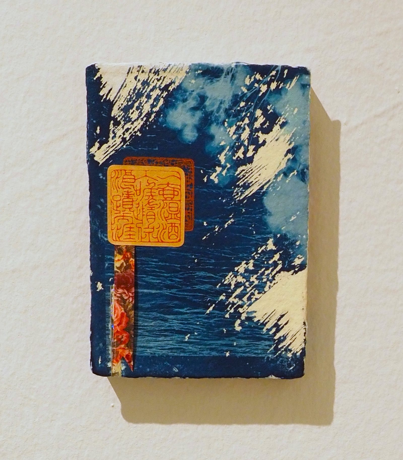 Cyanotype panel with orange seal impression and floral ribbon