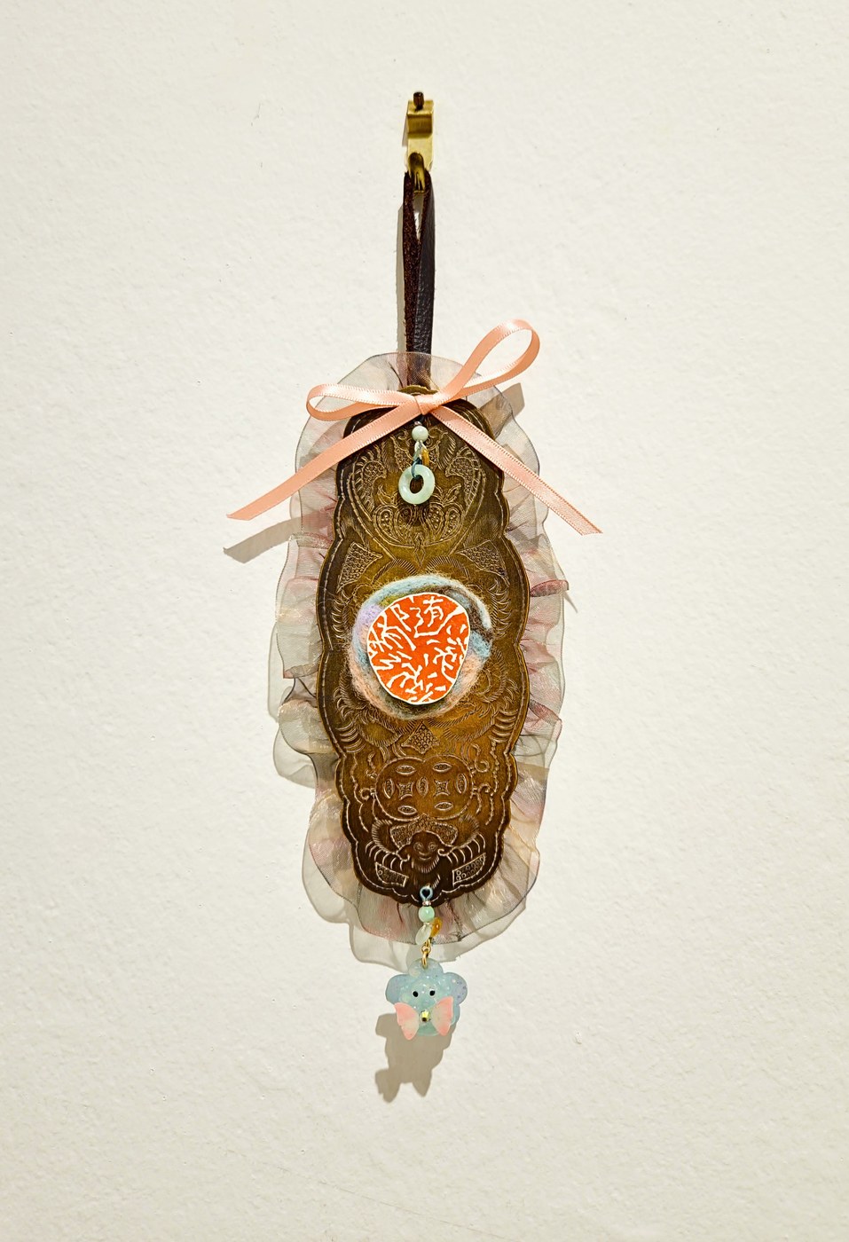 Elaborate hanging piece with ribbon, felt, and seal