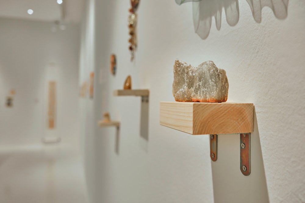 Uncarved stone on wooden shelf, gallery in background