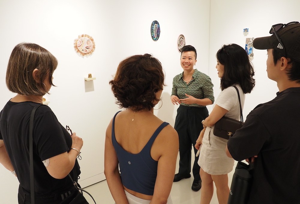 Michelle JN Lim talking visitors through her work at Art Outreach