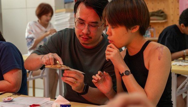Workshop participants carving seals