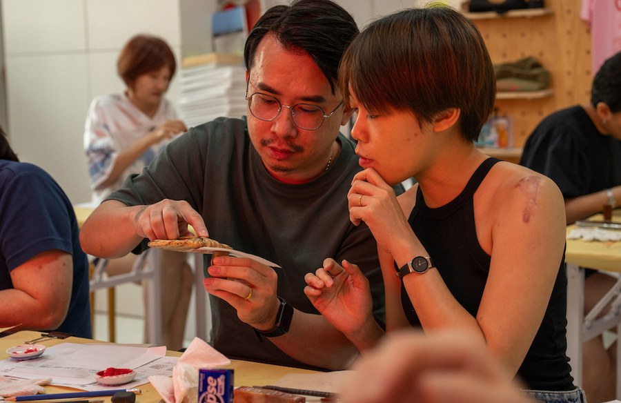 Participants examining a carved stone seal