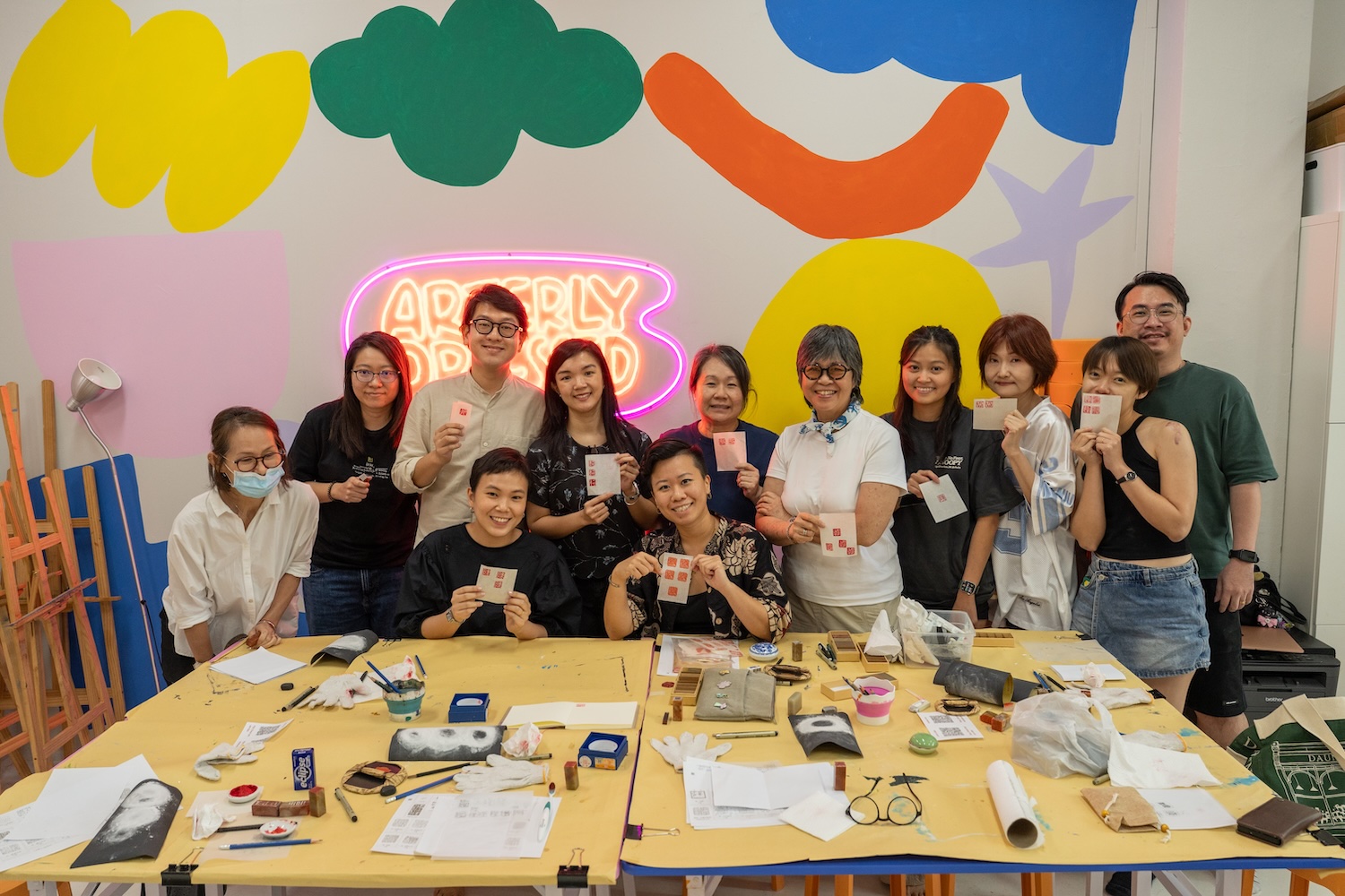 Workshop participants at Arterly Obsessed holding up their finished seals
